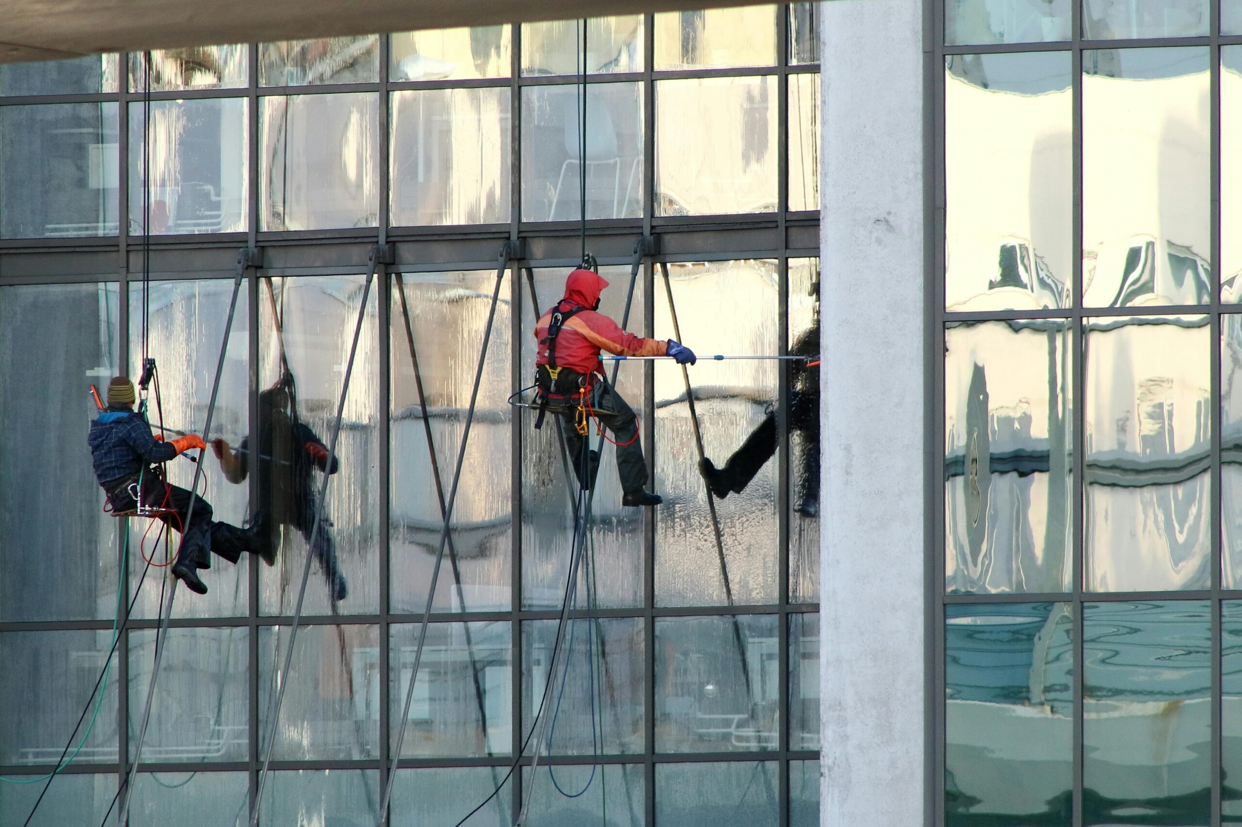 Professional window cleaners working on a skyscraper's exterior in Saint Petersburg, Russia.